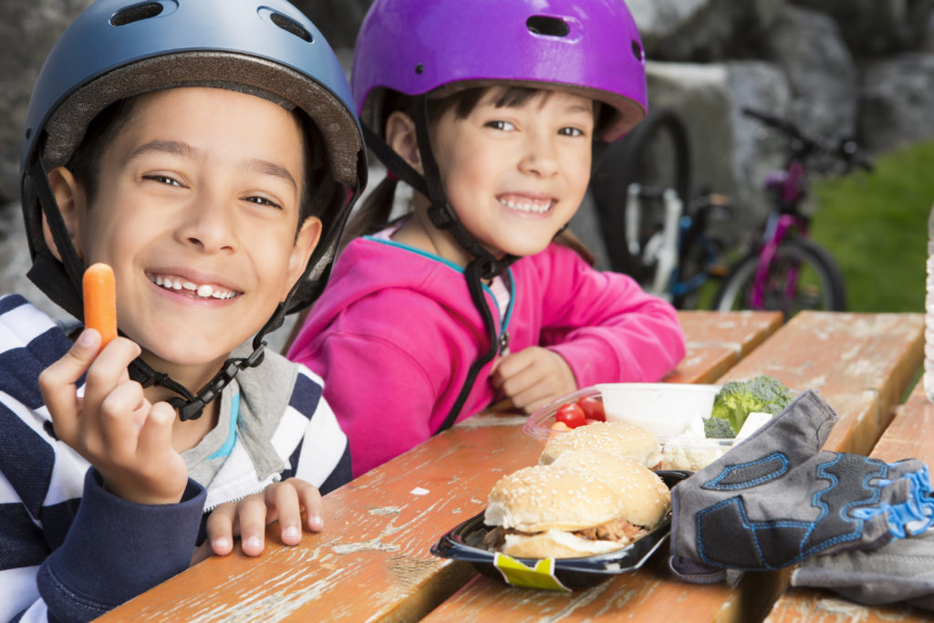 Young boy and girl taking a break to eat